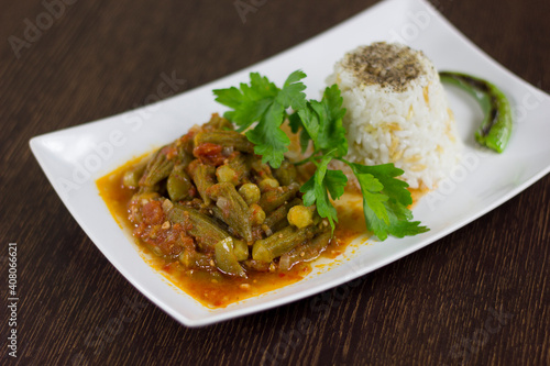 Okra with rice and parsley in a white plate