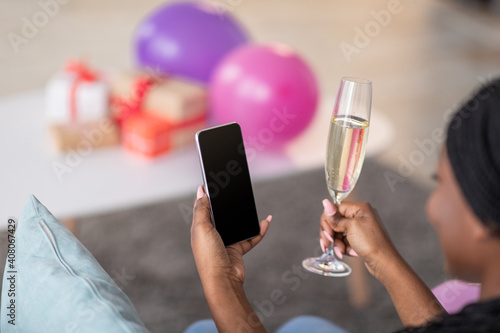 Smartphone with blank screen in black lady hand, celebration online