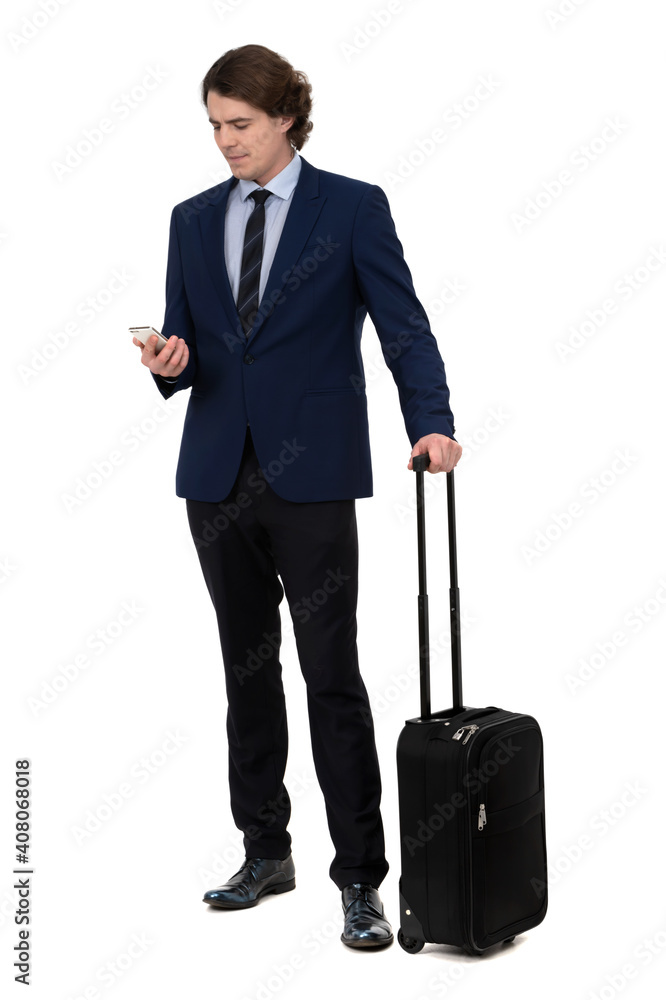 businessman with a suitcase standing and checking his phone isolated on white background businessman with a suitcase standing and checking his phone isolated on white background