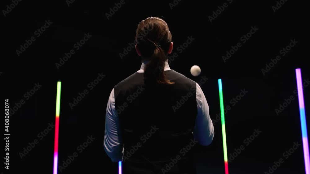 Orbital shot professional circus performer juggling with five white