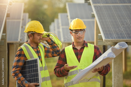 solar power station,Solar panels with technician,Future electrical production, asian engineers