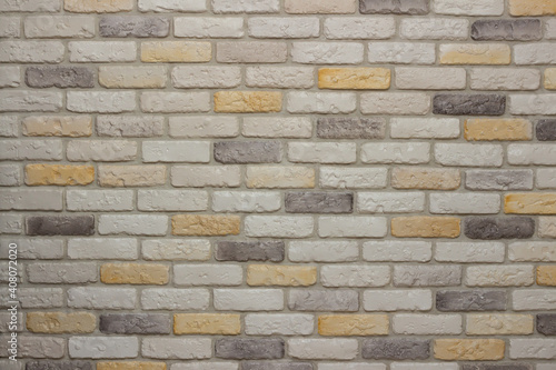 An example of facing an internal partition in a room of a house with decorative gypsum bricks with tiles in the shape of an antique wall, powder grout and colorless matte varnish