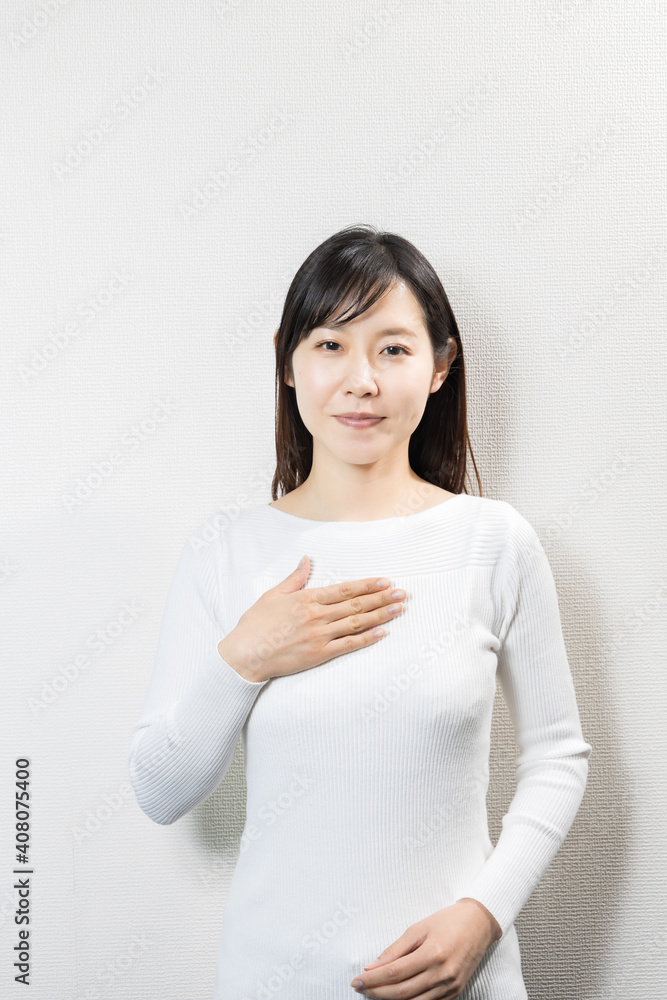 Woman putting her hand on her chest