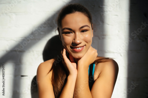 Portrait of beautiful woman. Happy fit girl in sportswear laughing