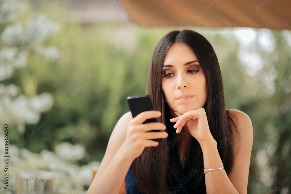 Unhappy Woman Charging Her Phone in a Restaurant Unhappy Woman Charging Her Phone in a Restaurant