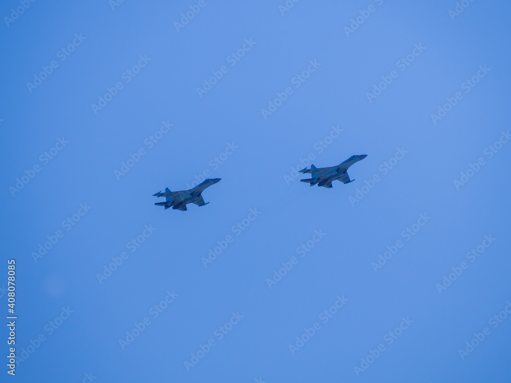 Russia, St. Petersburg - June 24, 2020: Russian military SU-35 plane of the Russian Air Force in flight at the Victory Parade in World War II. Russia, St. Petersburg - June 24, 2020: Russian military SU-35 plane of the Russian Air Force in flight at the Victory Parade in World War II.