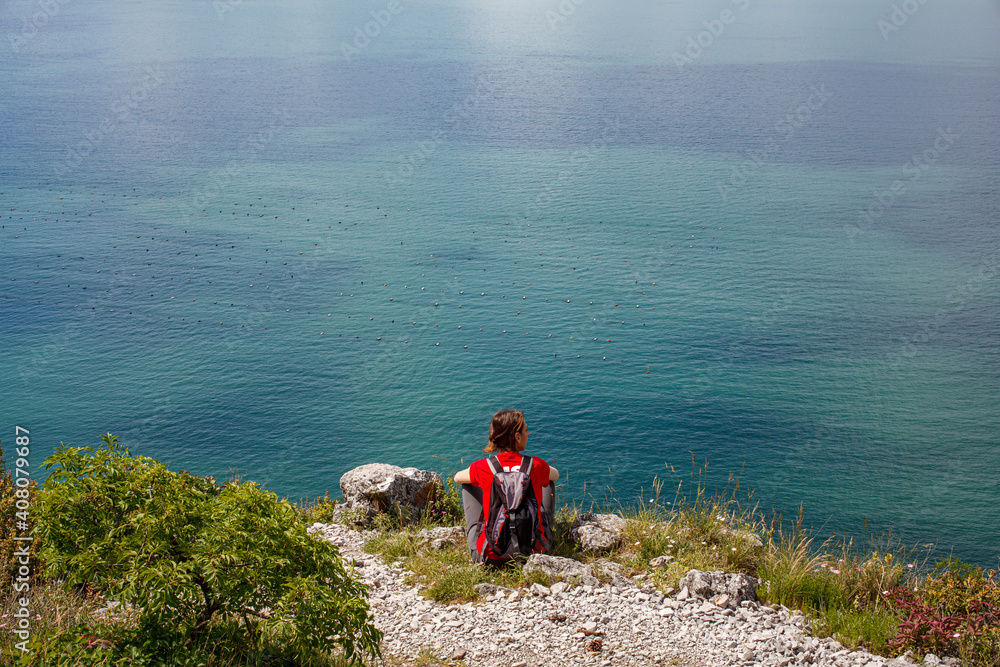 A woman looking the  sea from the karst edge