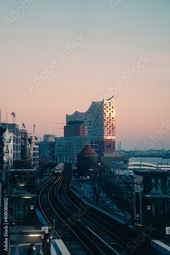 HAMBURG, GERMANY - December, 2020: The concert hall Elbphilharmonie in the Hafencity, part of the harbor, seen from Landungsbruecken train station with harbour in foreground © Max