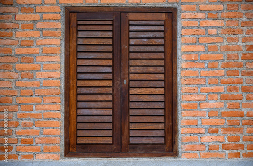 Wooden window on brick wall.