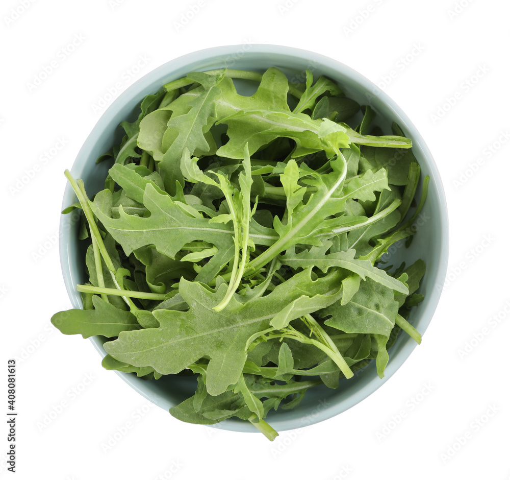 Delicious fresh arugula in bowl isolated on white, top view Delicious fresh arugula in bowl isolated on white, top view