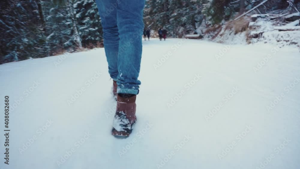 steps on the snow in winter shoes. slow motion steps on the snow in winter shoes. slow motion