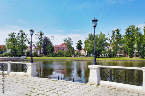 Pedestrian embankment of Upper Lake - artificial city pond, famous tourist attraction and popular leisure zone in Kaliningrad, Russia (formerly Koenigsberg) at sunny summer day photo