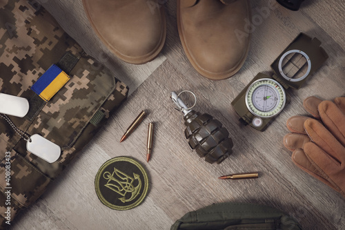 Flat lay composition with Ukraine military outfit and equipment on floor