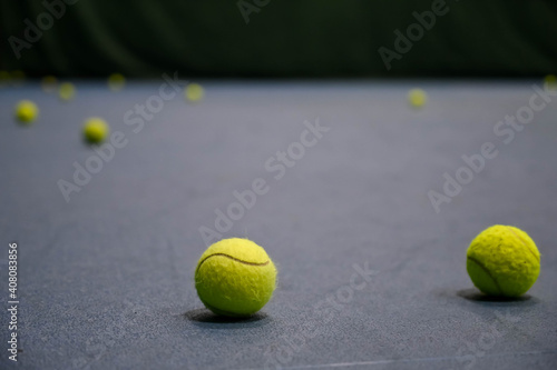Close-up of tennis balls on blue hard court. © Anastasia