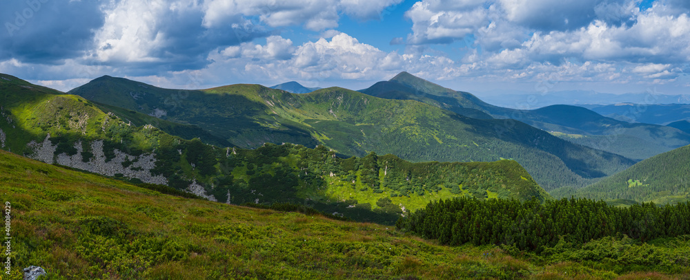 Summer mountain slope with picturesque rock formations. Shpyci mountain, Carpathian, Ukraine.