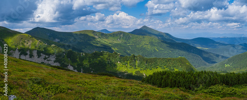 Summer mountain slope with picturesque rock formations. Shpyci mountain, Carpathian, Ukraine.