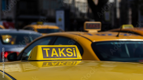 Close up of Istanbul taxi. Many taxis on street. The word "taksi" translated from Turkish means "taxi".