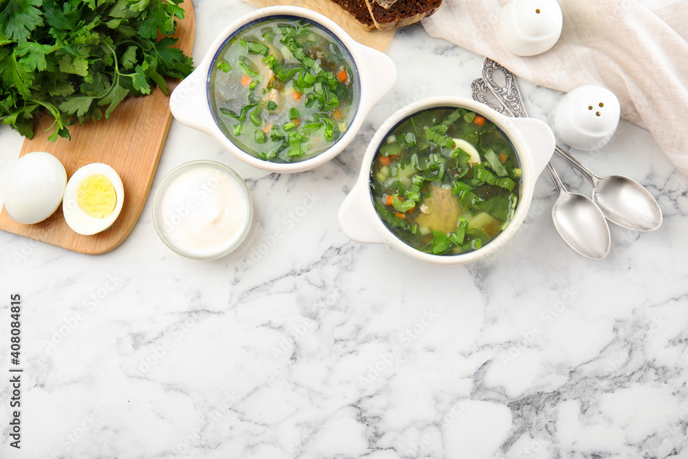 Delicious sorrel soup served on white marble table, flat lay. Space for text Delicious sorrel soup served on white marble table, flat lay. Space for text
