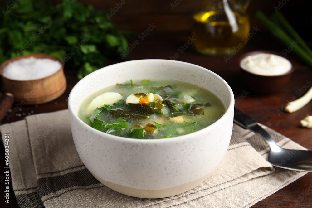 Delicious sorrel soup served on wooden table Delicious sorrel soup served on wooden table