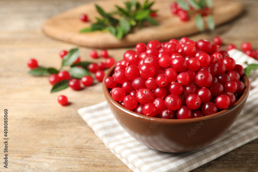 Tasty ripe cranberries on wooden table, closeup Tasty ripe cranberries on wooden table, closeup