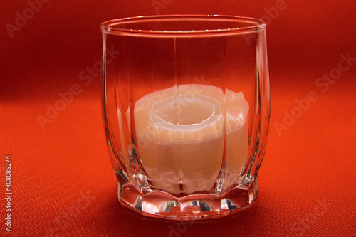 stationery tape in a glass goblet on an orange background