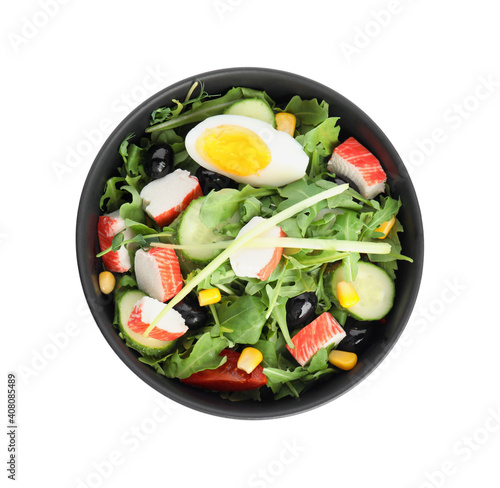 Tasty crab stick salad in bowl isolated on white, top view