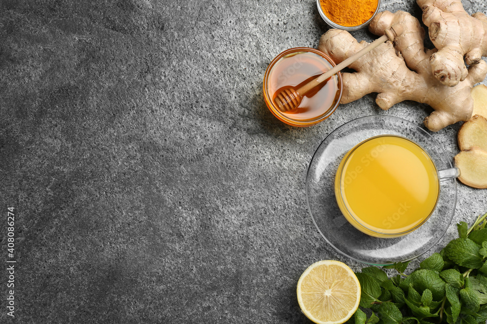 Flat lay composition with immunity boosting drink and ingredients on grey table. Space for text Flat lay composition with immunity boosting drink and ingredients on grey table. Space for text