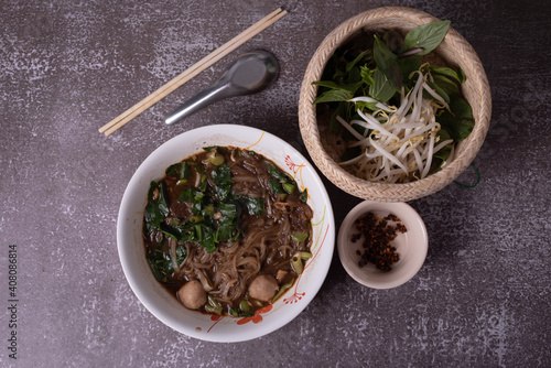 Thai noodle with meetball blood soup serve with sweet basil and beansprout 