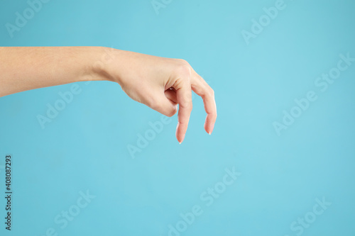 Woman imitating walk with hand on light blue background, closeup. Finger gesture