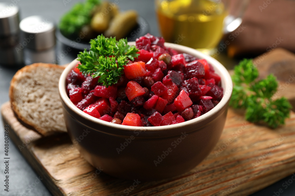 Traditional Russian salad vinaigrette on wooden board, closeup Traditional Russian salad vinaigrette on wooden board, closeup