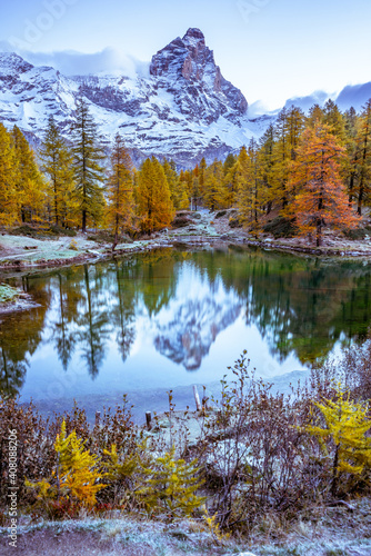Blue Lake and the surroundings area during the fall and changing of the colors. Foliage, reflection and snowy peaks.