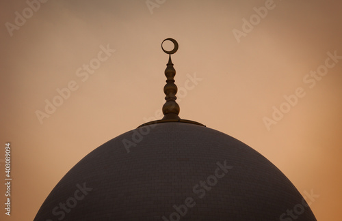 Famous Abu Dhabi Sheikh Zayed Mosque by dusk, UAE. Close up shot of the domes of the Grand Mosque. Crescent over the dome of the mosque. photo