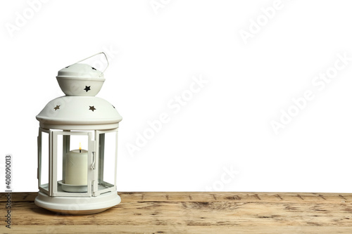 Decorative Christmas lantern with burning candle on grey background. Space for text