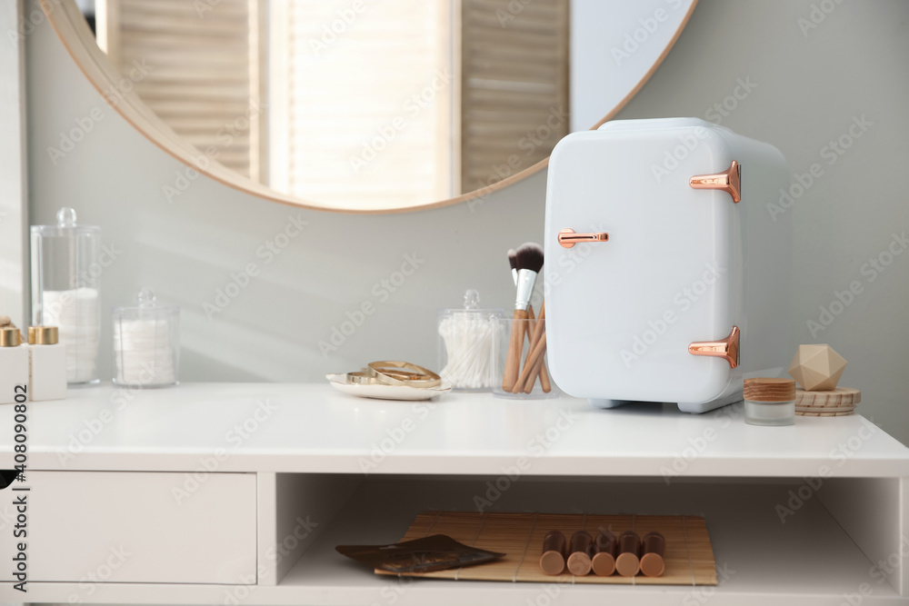 Ταπετσαρία Cosmetics refrigerator and skin care products on white vanity table indoors