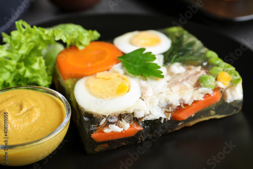 Delicious fish aspic with mustard on plate, closeup
