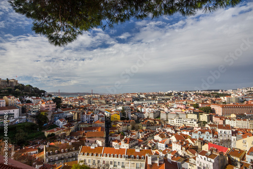 Lisbon, Portugal, 2017 : Tourists at the viewpoint Miradouro da Graca look at the Lisbon overview. Viewpoint Miradoura Da Graca - one of the best in the city and very popular among tourists.