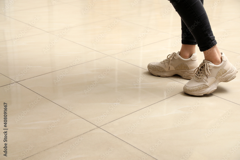 Woman standing on ceramic floor, closeup. Space for text Woman standing on ceramic floor, closeup. Space for text