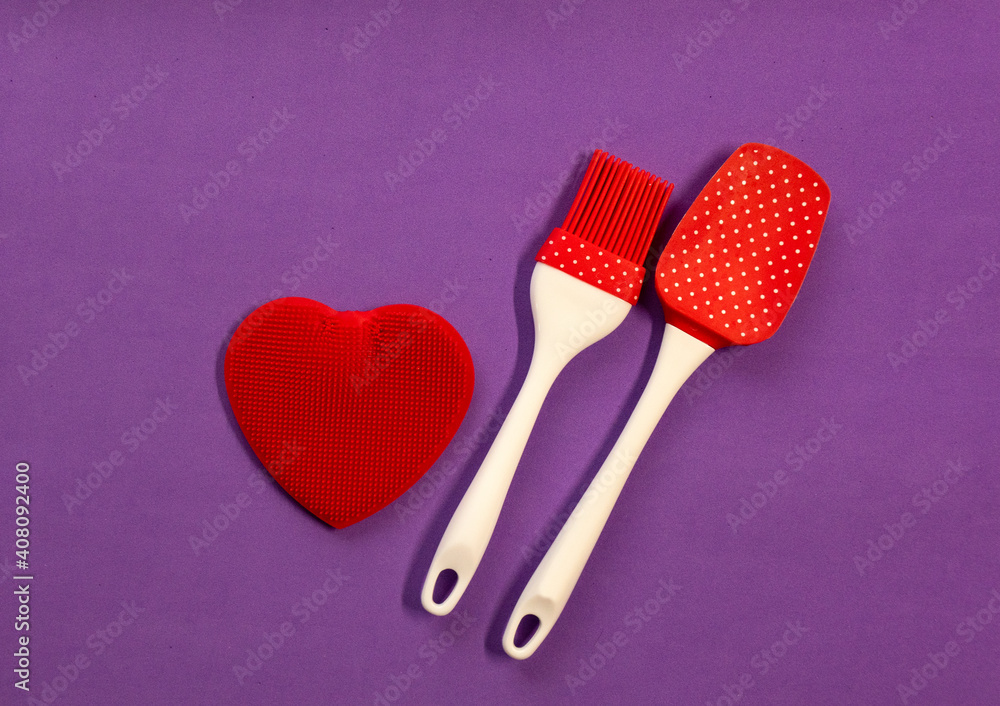 Silicone kitchen utensils with a red heart and a place for text. Kitchen banner for Valentine's Day.