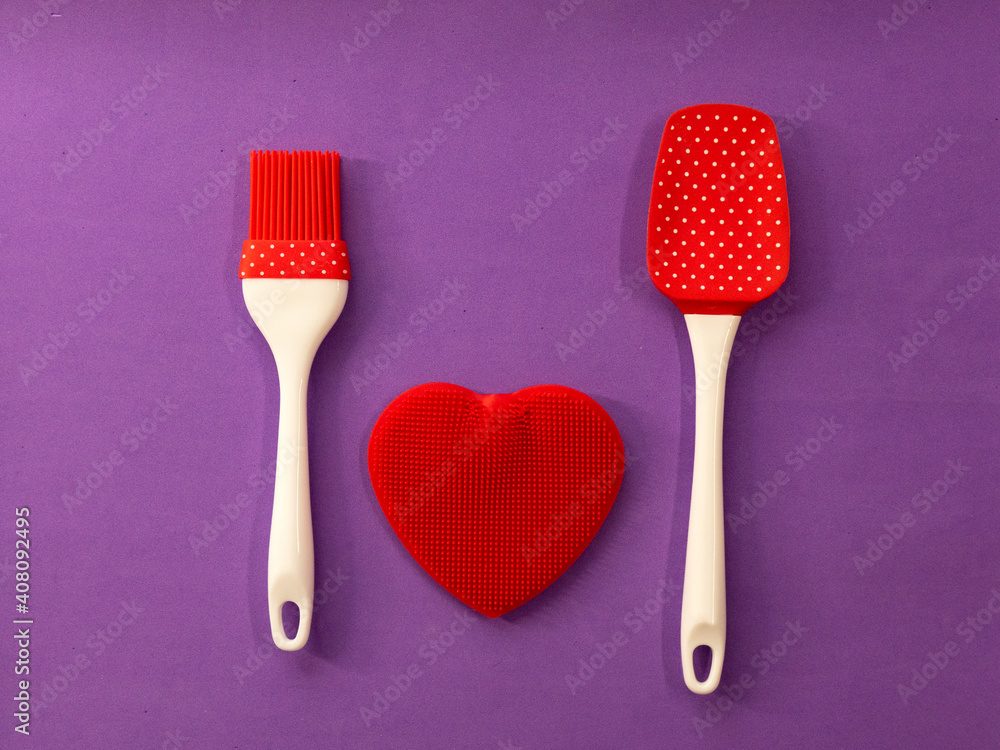 Silicone kitchen utensils with a red heart and a place for text. Kitchen banner for Valentine's Day. Silicone kitchen utensils with a red heart and a place for text. Kitchen banner for Valentine's Day.