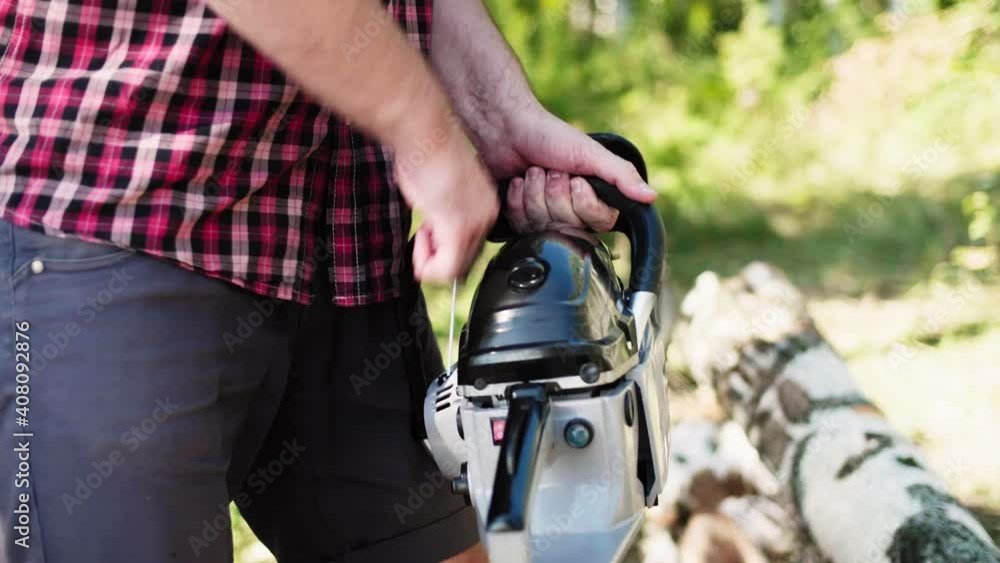 Lumberjack starts working, turn on ignition, pulls starter of chainsaw engine and starts sawing. Favorite work at summer sunny day in the forest. High quality 4k footage Lumberjack starts working, turn on ignition, pulls starter of chainsaw engine and starts sawing. Favorite work at summer sunny day in the forest. High quality 4k footage