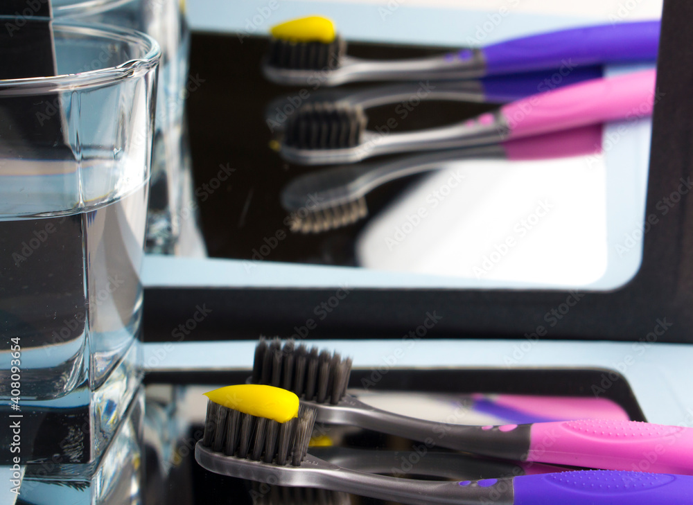 Children's toothbrushes, with toothpaste and reflection in the mirror. Children's toothbrushes, with toothpaste and reflection in the mirror.