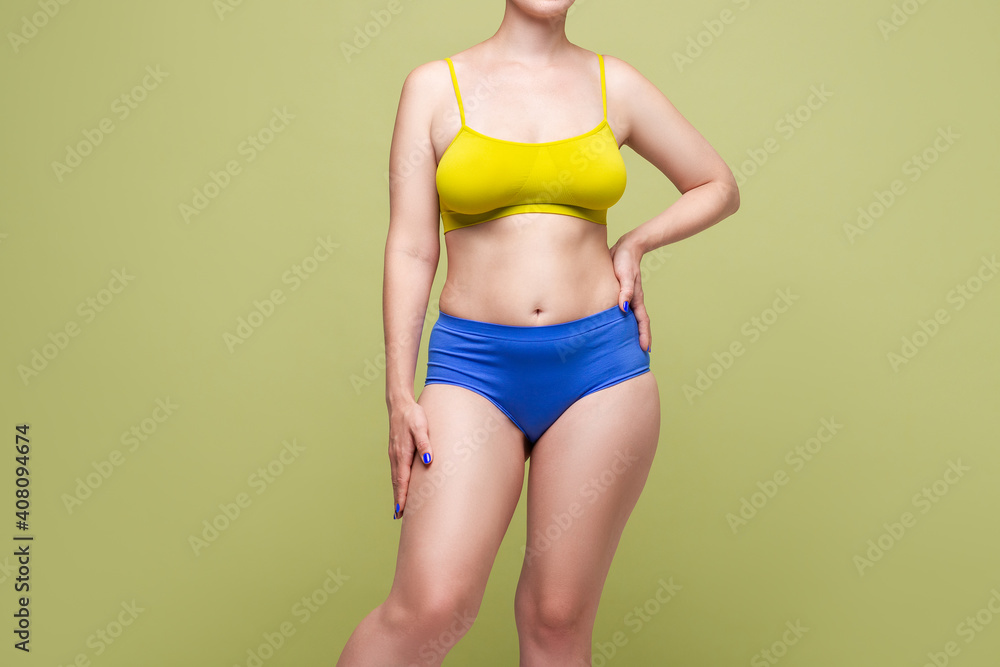 Beauty woman in colorful underwear with big natural breasts on light green background Beauty woman in colorful underwear with big natural breasts on light green background