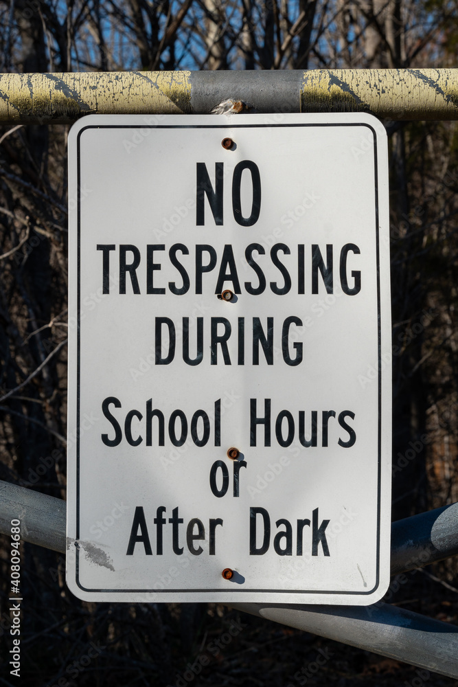 No trespassing during school hours or after dark sign No trespassing during school hours or after dark sign
