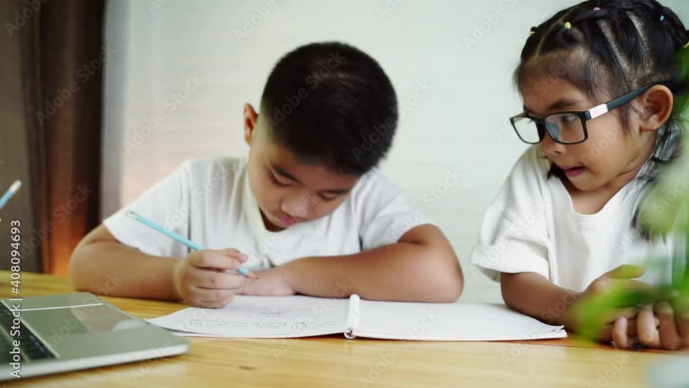 Asian boy and girl student online learning class study online with laptop at home. Asian boy and girl student online learning class study online with laptop at home.