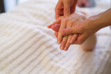 Wrist massage. massage therapist puts pressure on a sensitive point on a woman's hand. Physiotherapist massaging her patients hand in medical office