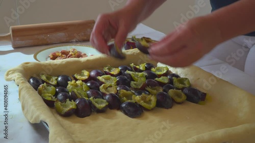 Woman preparing fresh plum pie 