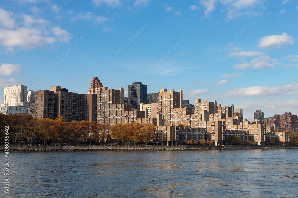 Roosevelt Island Skyline along the East River in New York City during Autumn with Colorful Trees Roosevelt Island Skyline along the East River in New York City during Autumn with Colorful Trees
