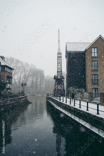 Old vintage dockside crane on snowy day in west part of the river Thames photo