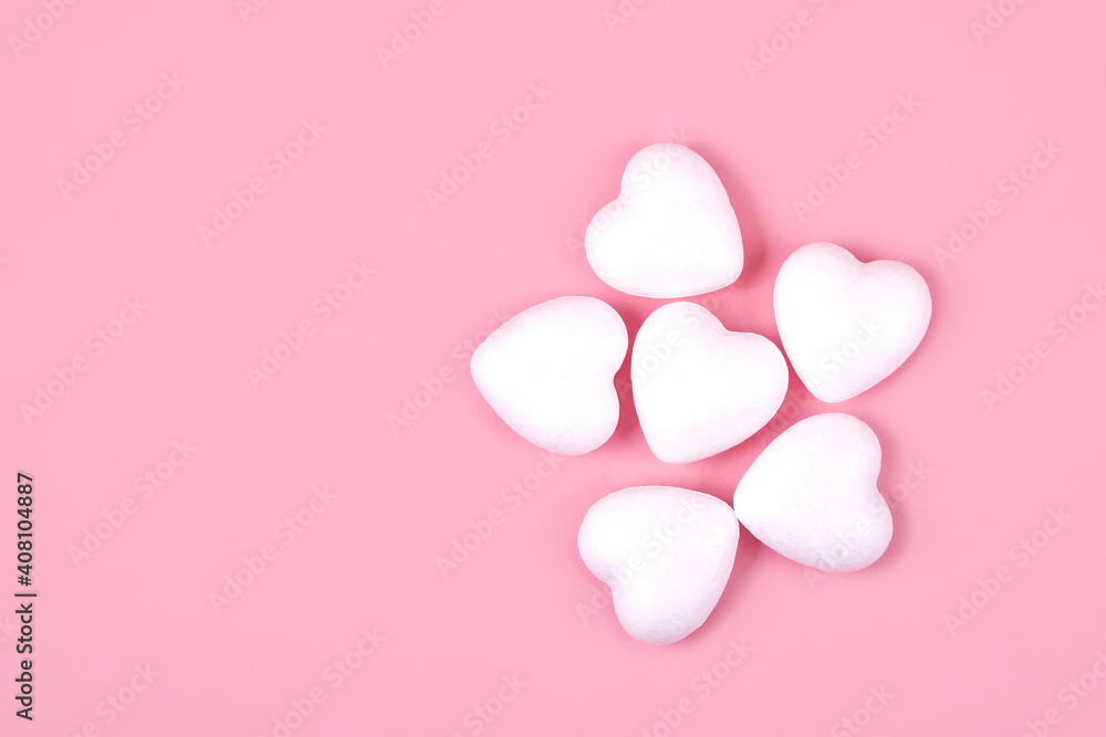 Some white hearts on a pink background