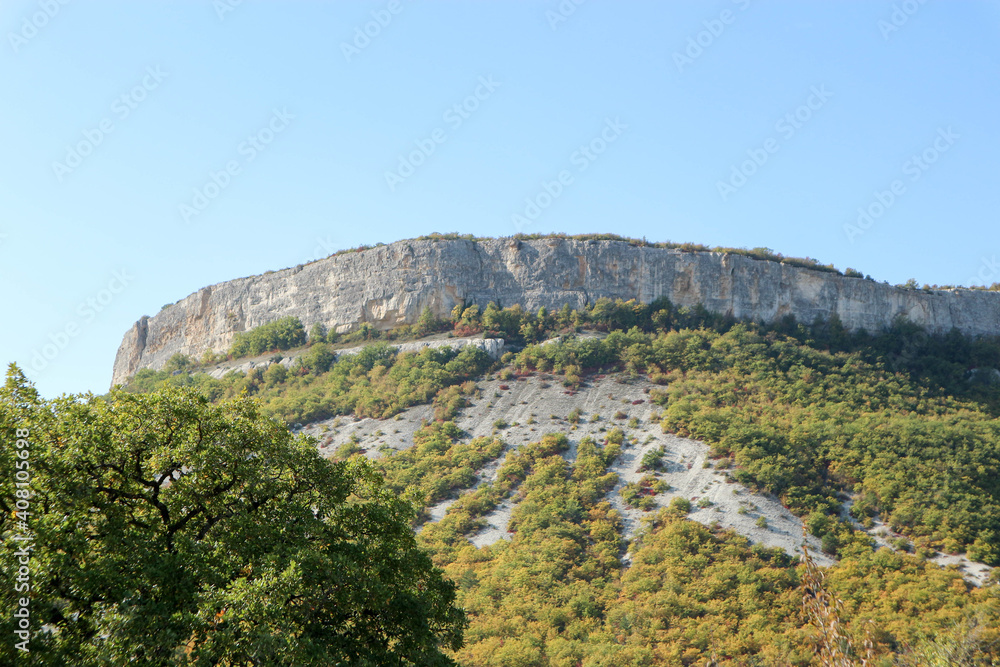 autumn in the mountains limestone cliff surrounded by colorful forest